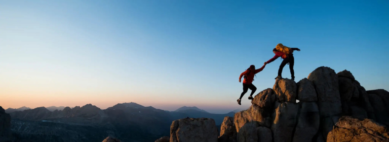 Un sportif aidant son coéquipier en montagne pour restaurer la confiance en soi dans le sport par l'entraide